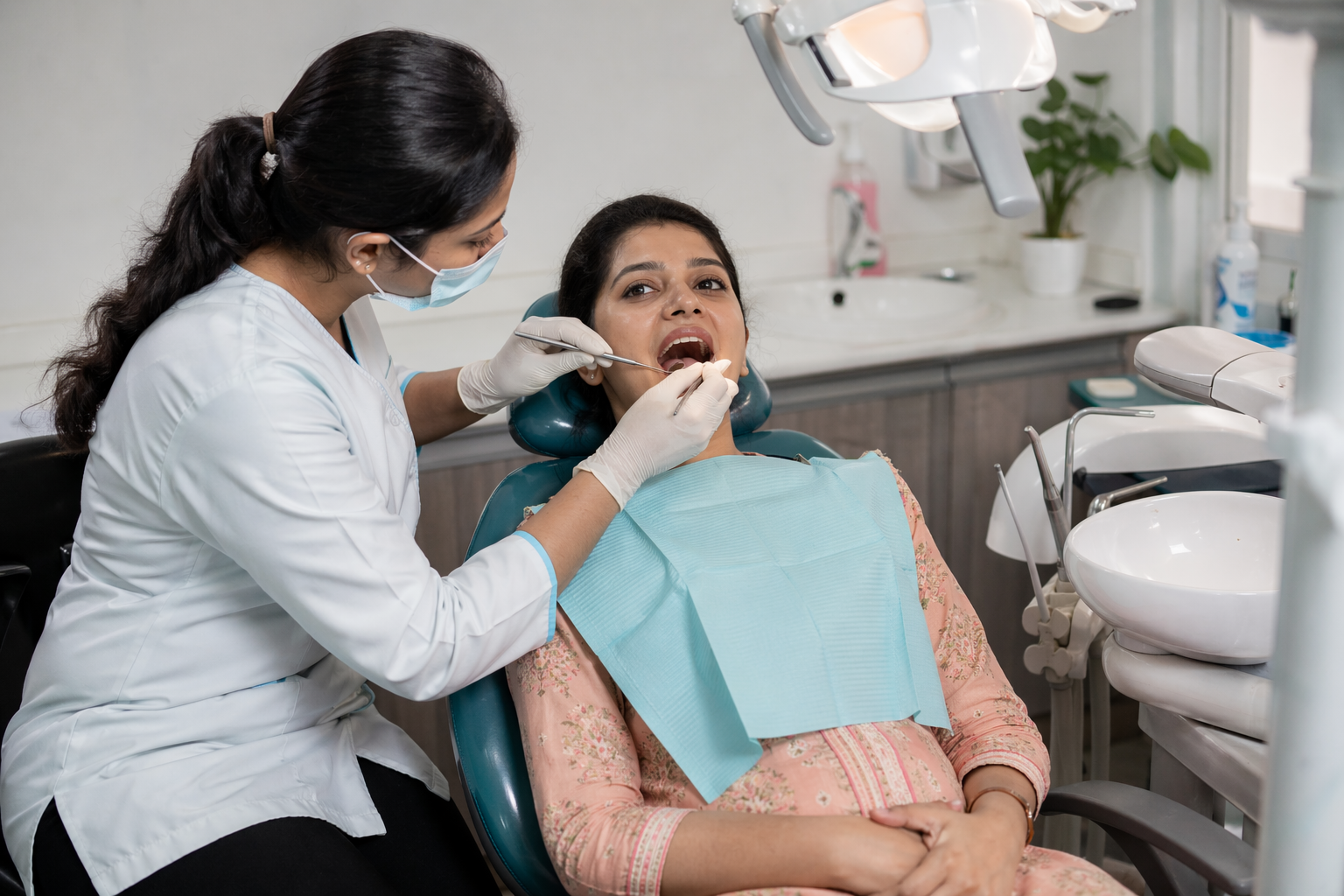 Indian female dentist treating an Indian patient